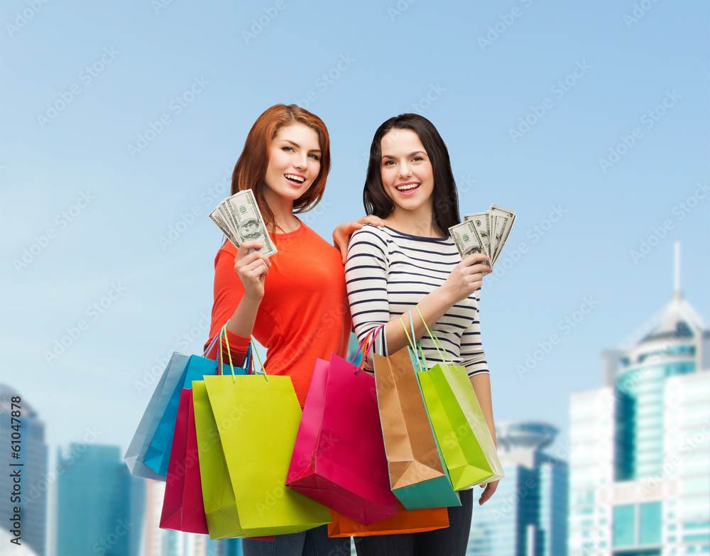 Wall mural smiling teenage girls with shopping bags and money