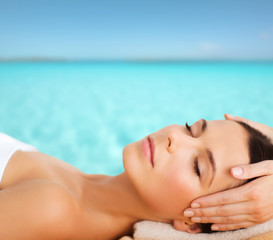 beautiful woman in spa salon having facial