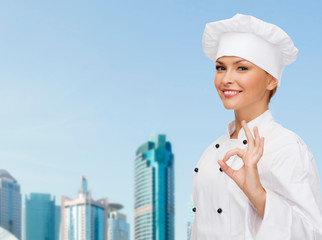 smiling female chef showing ok hand sign