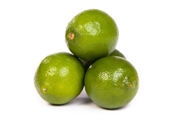 Group of whole limes  and one half lime on white