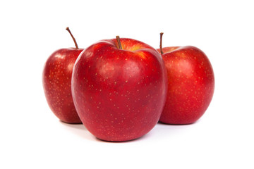 Three shiny red apples isolated on white