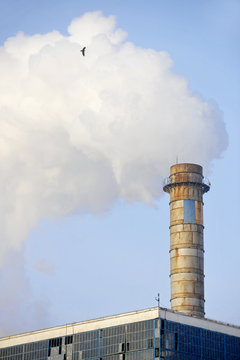 Industrial chimney with huge cloud of smoke