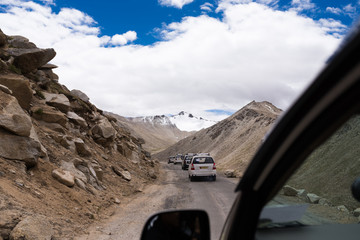 Fototapeta na wymiar row of cars running through the mountains