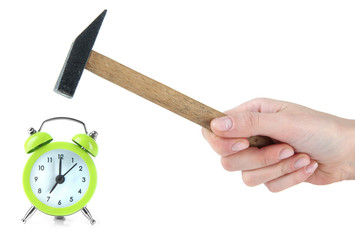 Hammer in hand and alarm clock isolated on white