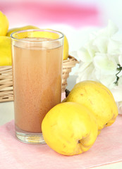 Sweet quince with juice on table on light background