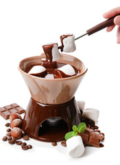Chocolate fondue with marshmallow candies, isolated on white