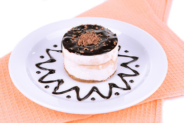 Sweet cake with chocolate on plate on table close-up