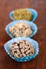 Set of chocolate candies, on wooden background