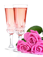 Composition with pink sparkle wine in glasses and pink roses