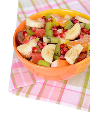 Sweet fresh fruits in bowl on table close-up
