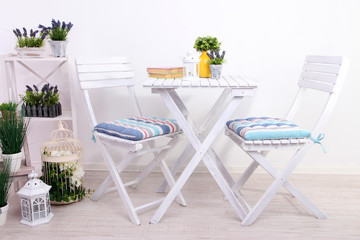 Garden chairs and table with flowers