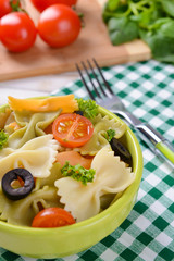 Delicious pasta with tomatoes on plate on table close-up