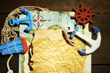 Old paper with sea accessories, isolated on wooden background