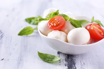 Foto op Plexiglas Tasty mozzarella cheese with basil and tomatoes in bowl, © Africa Studio