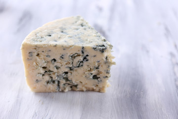 Tasty blue cheese, on wooden table