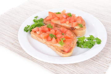 Delicious bruschetta with tomatoes on plate on table close-up