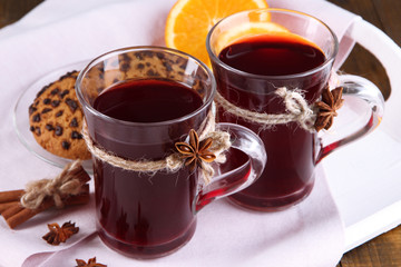 Mulled wine with oranges on table close up