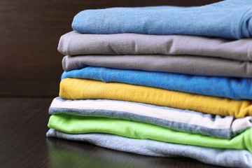 Stack of colorful clothes, on dark background