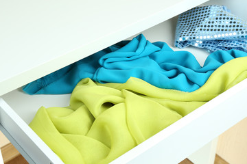 Open drawer with fabrics close up