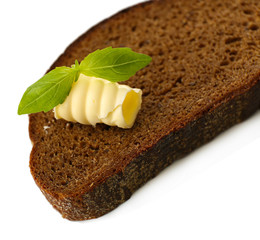 Slice of rye bread with butter, isolated on white