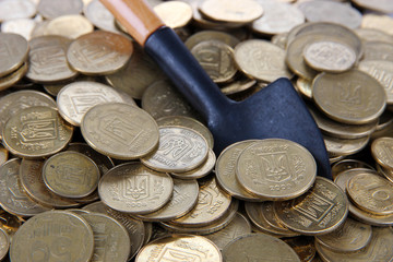 Coins with shovel close up