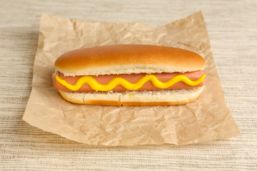 Tasty hot dog on paper