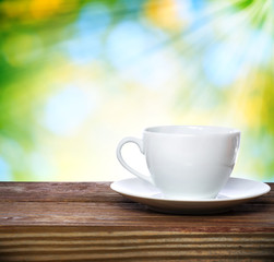 Coffee cup on shiny green background