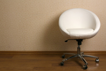 White armchair against wall in room
