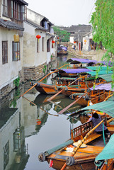 Fototapeta na wymiar Zhouzhuang, Tourist boat in a village canal.