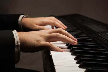 Fototapeta na wymiar Piano keys and human hands