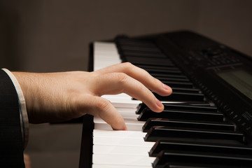 Fototapeta na wymiar Piano keys and human hand