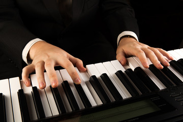Piano keys and human hands