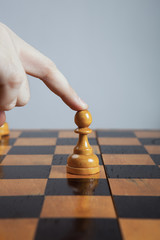 man makes a move chess pawn