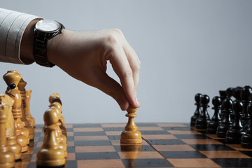 man makes a move chess pawn