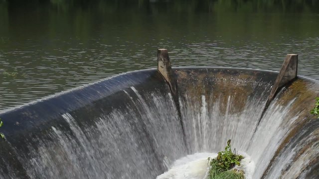 Water flowing from spillway of dam.