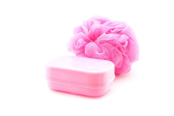 pink soapbox and shower scrubber on white background