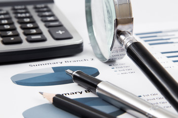 magnifying glass on the business report