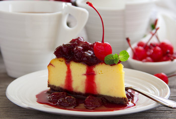 A slice of cheesecake with cherry sauce.