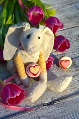 süßer Hase mit Blumen und Pralinen