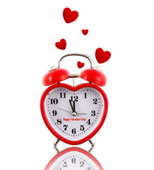 Heart-shaped alarm clock ringing with hearts isolated on white