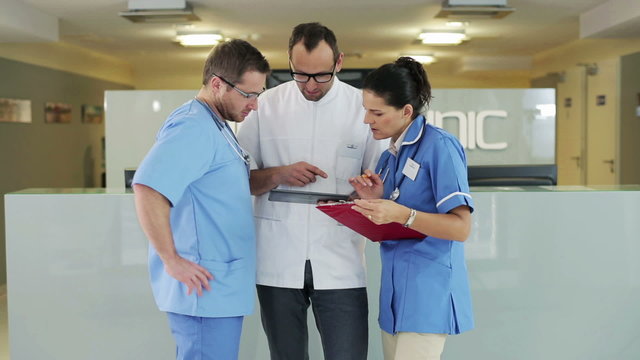 Group of medical workers consulting something in hospital