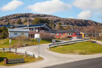 Norwegian village with colorful wooden houses on rocky hill