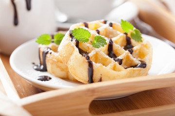 Belgian waffles with chocolate and powder sugar for breakfast