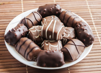 chocolate pralines on old wooden table