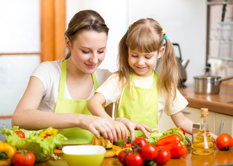 mom and kid girl preparing healthy food