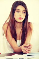 Young woman's paying bills.