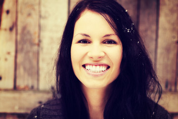 Happy woman in brown cardigan in winter day.