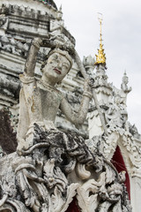 White Phra Mae Thorani Statue With Pagoda in Thailand