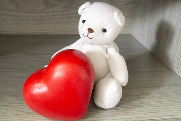 White bear with heart in small room