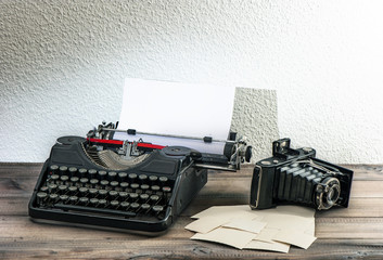 old typewriter and vintage photo camera. antique objects